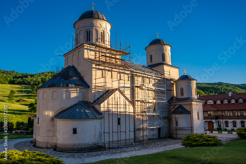 Exterior of Mileseva Monastery church building under renovation scaffolding. Serbian Orthodox medieval architecture and heritage preservation concept during sunset light. Prijepolje, Serbia 29.05.2026
