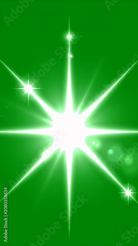 Large bright white starburst flare on green background.
