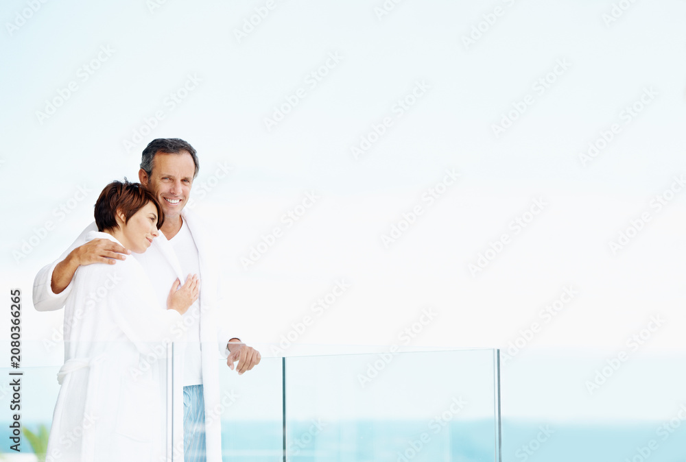 Fototapeta premium Smile, couple and love on balcony with hug, affection and bonding together at holiday resort. Portrait, people and terrace with space for fresh air, healthy relationship and commitment for vacation