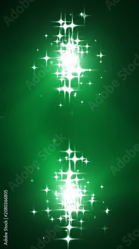 Sparkling white lights on vertical green backdrop.