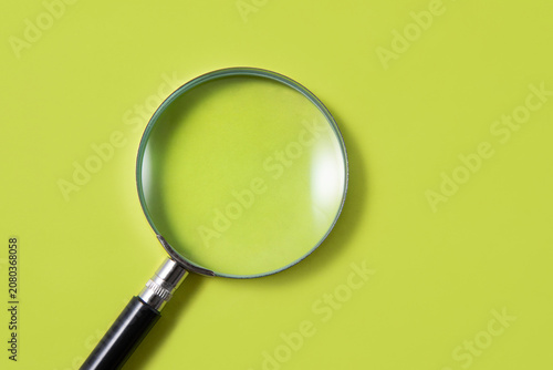 Картината върху платно magnifying glass on green background