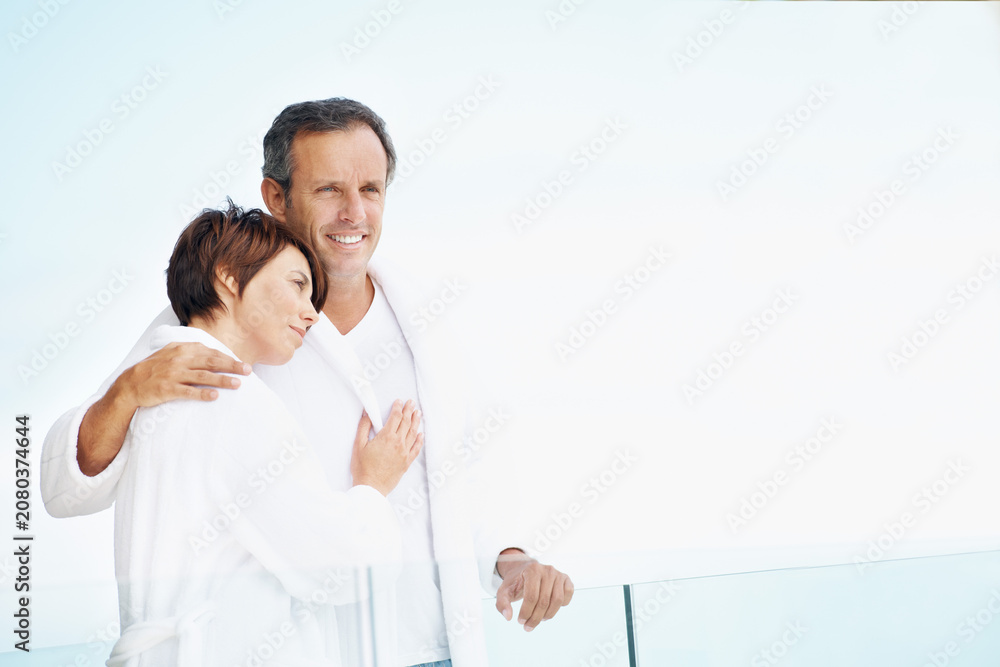 Fototapeta premium Thinking, couple and love on balcony with hug, affection or bonding together at holiday resort. Space, people and terrace at hotel for fresh air, healthy relationship and view on anniversary vacation