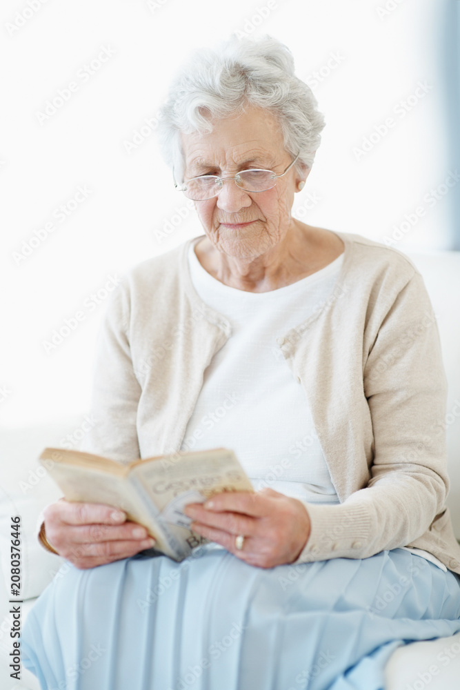 Obraz premium Calm, book or old woman in home with reading, fantasy novel or insight in literature activity. Relax, glasses or senior person with fairytale, peaceful moment or fiction story in retirement hobby.