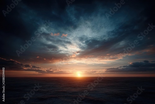 Stunning dramatic sunset over a calm ocean horizon.