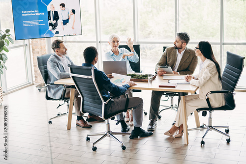 Foto Group of professionals in formal business attire holding a meeting in a modern o