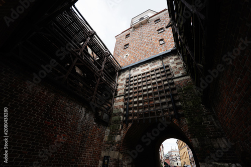 Photos Historic Krakow Gate in Lublin Poland with medieval brick tower and wooden gateh