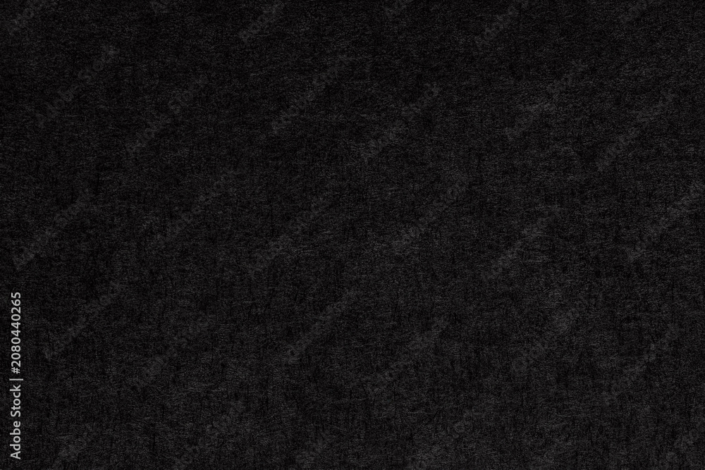 Fototapeta premium Macro 1:1 close-up of black cardstock paper showing a fine fibrous texture, ideal for stationery, packaging, and elegant minimalist design background projects.