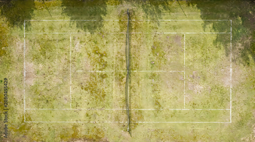 Naklejka premium Aerial view of a worn green tennis court surface with white boundary lines