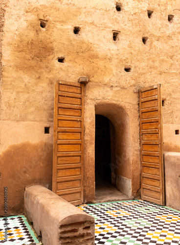 Historic Wooden Doors and Zellige Mosaic Floor at an Ancient Royal Palace in Marrakech