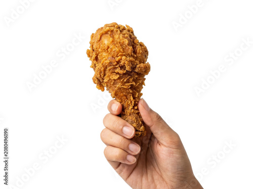 Hand holding a crispy fried chicken leg against a white background