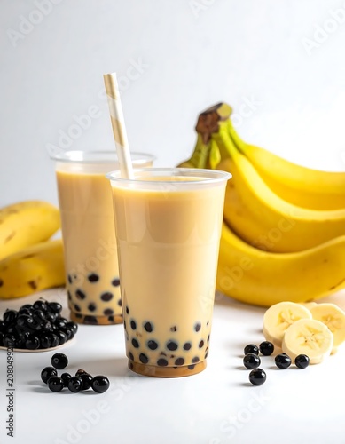 Bubble tea with bananas and tapioca pearls on white background.
