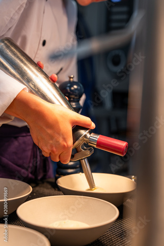 Fotografi Chef torching a dessert with a blowtorch