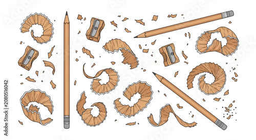 Set of graphite pencils with mechanical sharpeners and scattered wood shavings on a white background.