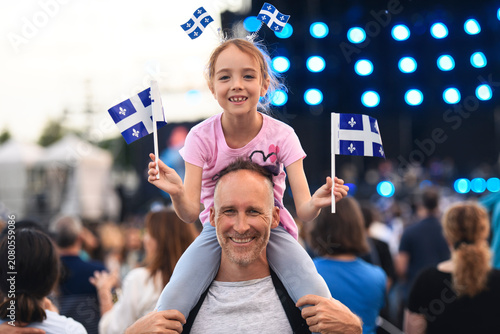 Father and daughter on national quebec day. The child is on the shoulder.