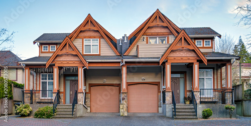 Obraz na plátně Craftsman Style Duplex Townhouse with Separate Garages and Paved Driveway