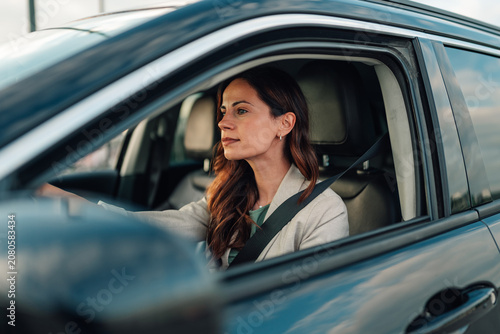 Bild auf Leinwand Woman driving car, traveling on road, commuting to work, enjoying journey, feeli