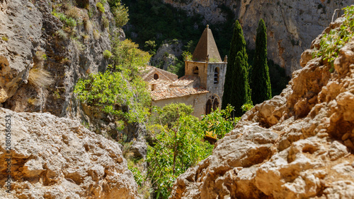 Historic church framed by cliffs in the mountains of Moustiers-Sainte-Marie.
