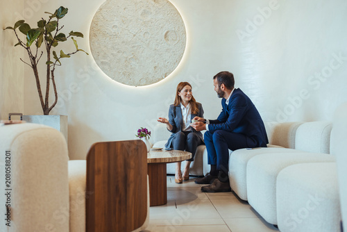 Business Colleagues Having Professional Meeting in Modern Office Lounge Discussing Strategy and Ideas
