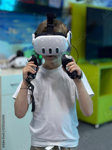 Curious child exploring virtual reality technology with VR headset and controllers in an entertainment center.
