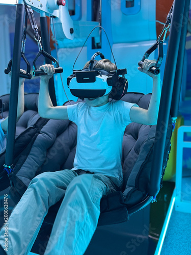 Young boy discovering a virtual world through immersive VR technology and interactive digital experiences.