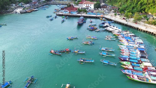Aerial Drone View of Traditional Fishing Boats Moored at Sadeng Fishing Port During Sunset, Yogyakarta, Indonesia