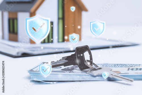 House keys on US dollar banknotes with a model home and digital shield icons. Home insurance, mortgage protection, real estate investment, property security and financial risk management concept.