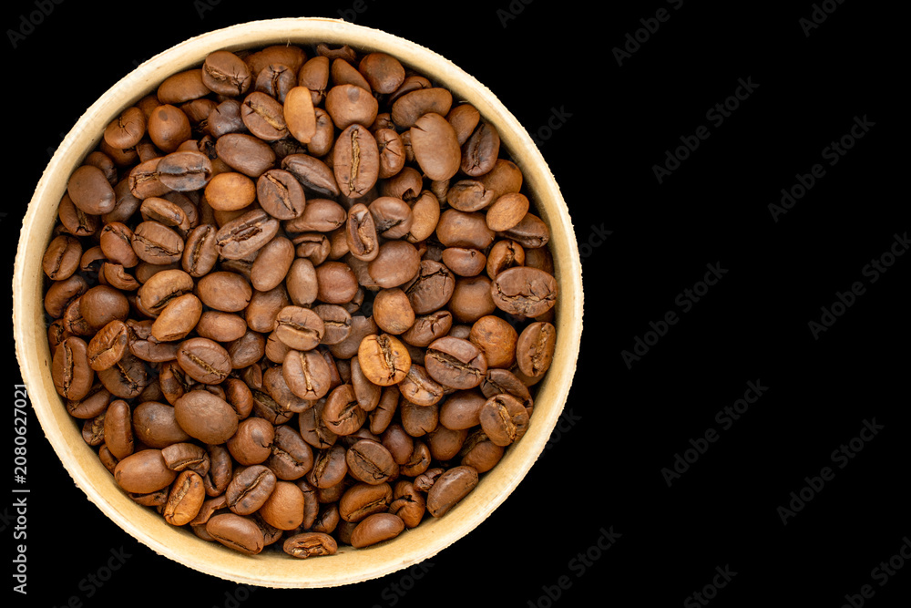 Fototapeta premium Roasted coffee beans isolated on black background. Top view.