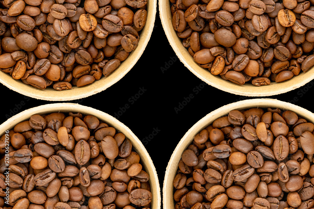 Fototapeta premium Roasted coffee beans isolated on black background. Top view.