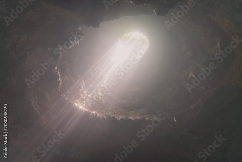 Obraz na płótnie Jomblang cave in Gunungkidul is a doline formed by a cave collapse a large, natural sinkhole with steep edges surrounded by trees
