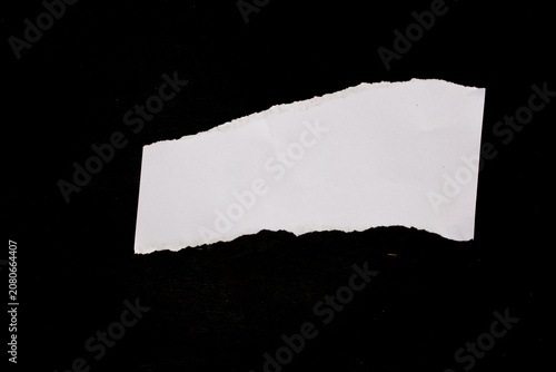 White paper scraps on black background