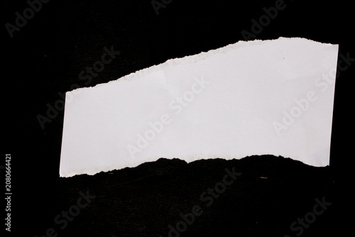 White paper scraps on black background