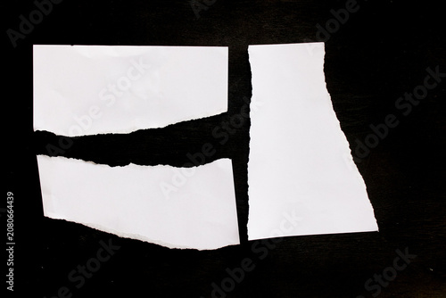 White paper scraps on black background