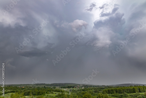 Dramatic sky with thunderclouds over countryside