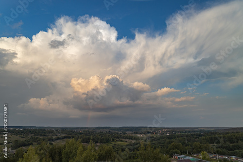 Beautiful thunderclouds at sunset over the countryside