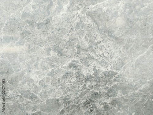 Close-up shot of a textured gray marble surface with natural white veining patterns, suitable for backgrounds and design elements.