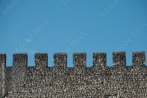 antique wall. Ancient fortress wall against the blue sky. fragment of a fortress wall as an antique background