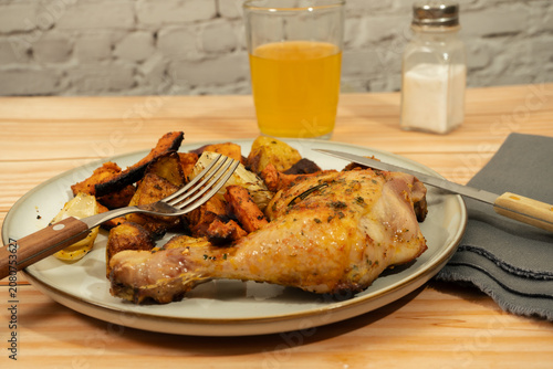 Canvas Print Roasted chicken leg with root vegetables dinner plate