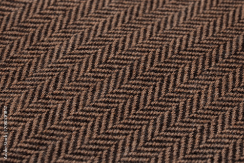 Brown and Black Herringbone Wool Fabric Texture Close-Up Macro with Classic Zigzag Weave Pattern Background