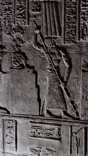 Dendera temple interior sanctuary with illuminated hieroglyphic walls and ritual