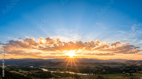 Natural cloud formation at sunset over mountains and river