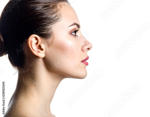 A woman's face and shoulder in profile with her hair pulled back