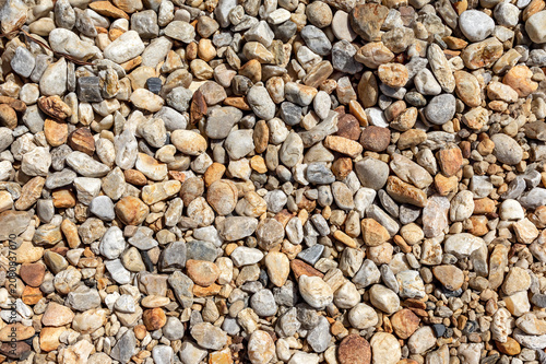 Heterogeneous scattering of small pebbles and stones, natural stone texture