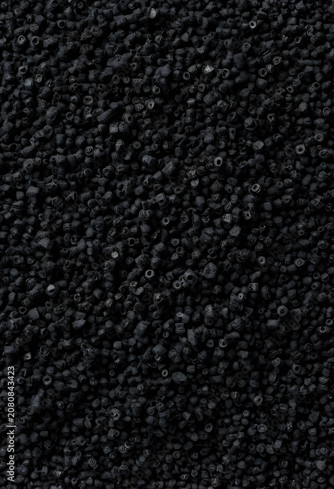 Fototapeta premium activated carbon granules close-up on black surface