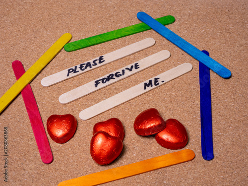 Three plain craft sticks in the center display the handwritten message 