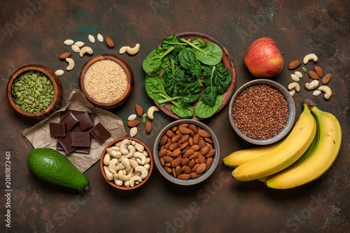 Magnesium rich food on dark grunge background, top view, flat lay, copy space. Various foods containing Mg