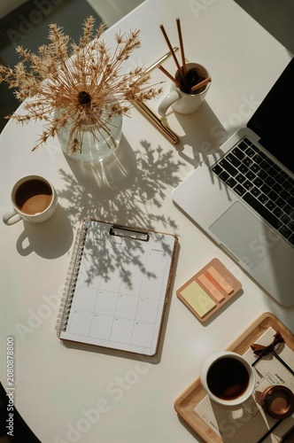 Working at a Bright Table With Coffee, Calendar, and a Laptop in a Sunny Room