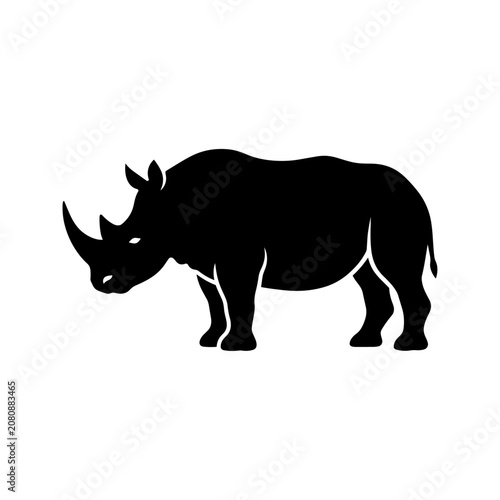 A black silhouette of a rhinoceros stands alone in a plain environment.