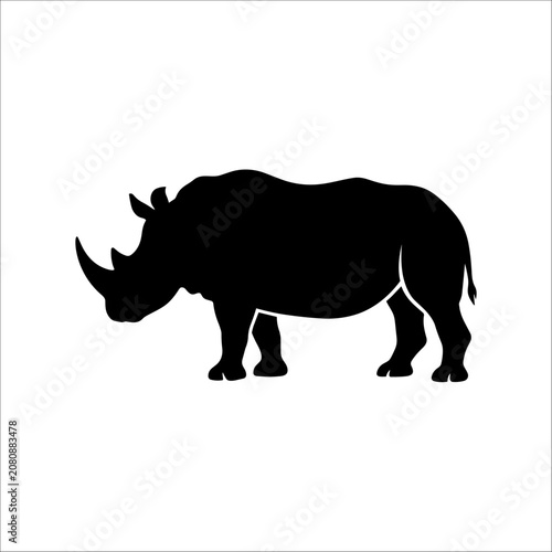 A black silhouette of a rhinoceros stands alone in a plain environment.