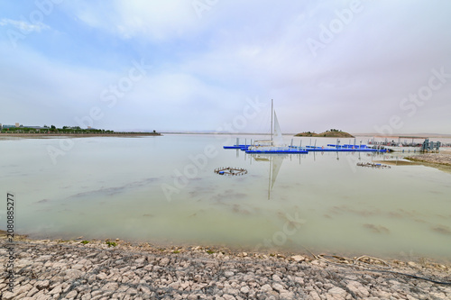 Peaceful Wuhai Lake Landscape Featuring White Boat Under Clear Blue Sky in Inner Mongolia