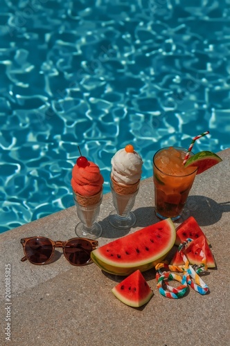 Summer Treat by the Pool With Ice Cream, Watermelon, and a Drink in a Warm Se...